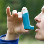 Asthma patient inhaling medication for treating shortness of breath and wheezing. Chronic disease control allergy induced asthma remedy and chronic pulmonary disease concept.