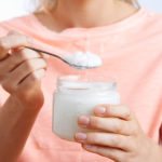 Close Up Of Woman With Spoonful Of Coconut Oil